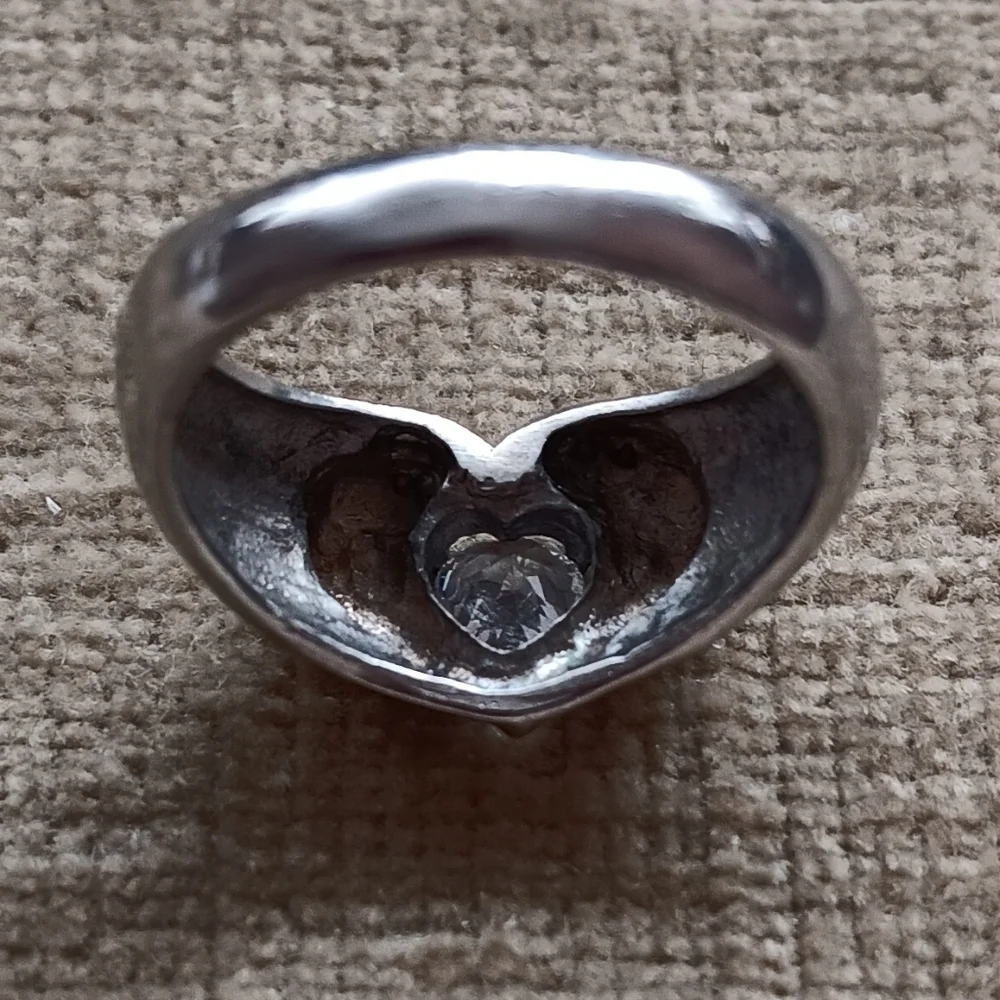 Silver Ring with a Heart Design Featuring a Sparkling Rhinestone Centerpiece.
